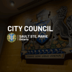 City council meeting - City Shield in the dark background