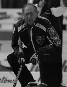 Alan Harnden in a curling position on the ice