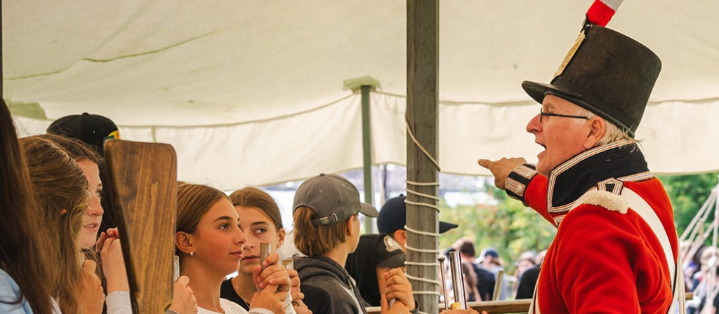 A group of young kids on a historical tour at the Ermatinger Clergue National Historic Site