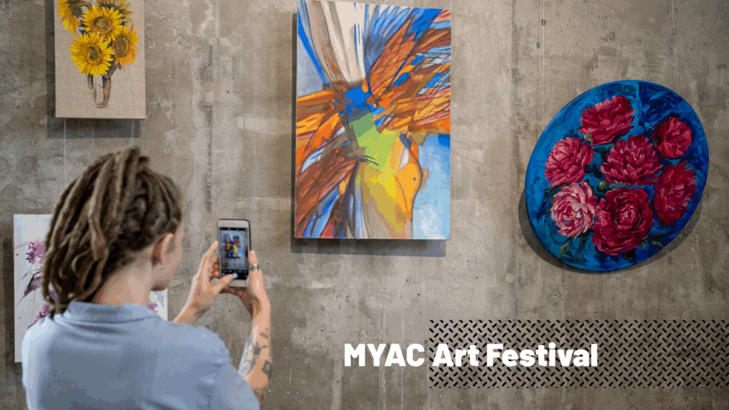 Student taking photo of art with cell phone
